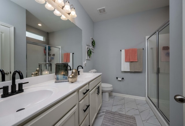 bathroom featuring vanity, toilet, and walk in shower