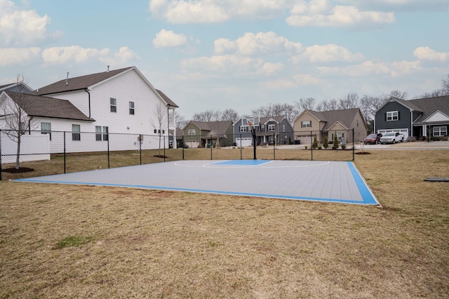 view of basketball court featuring a yard