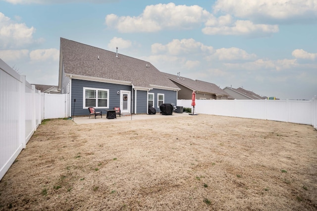 rear view of property with a lawn and a patio area