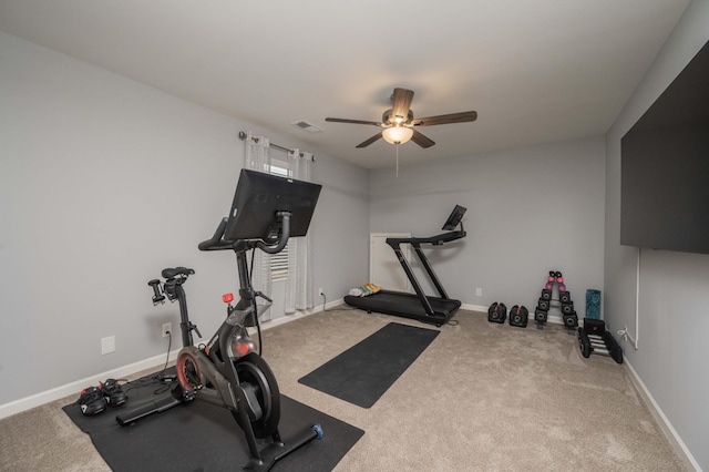 workout area featuring ceiling fan and carpet flooring