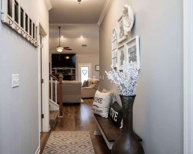 hall featuring ornamental molding and dark hardwood / wood-style floors