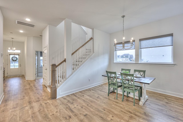 dining room featuring light hardwood / wood-style flooring and a chandelier