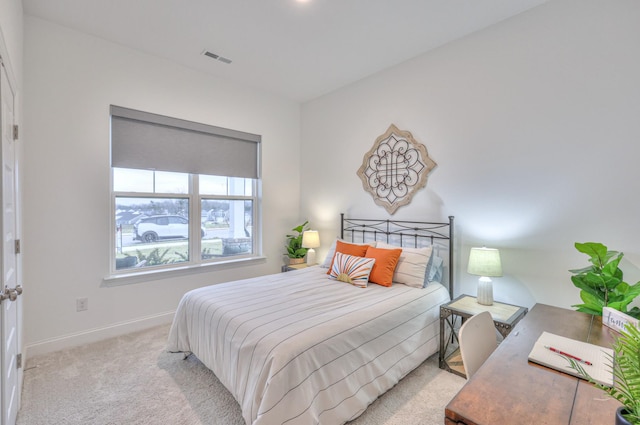 bedroom with light colored carpet