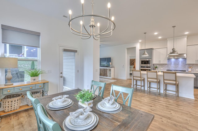 dining room featuring an inviting chandelier and light hardwood / wood-style floors