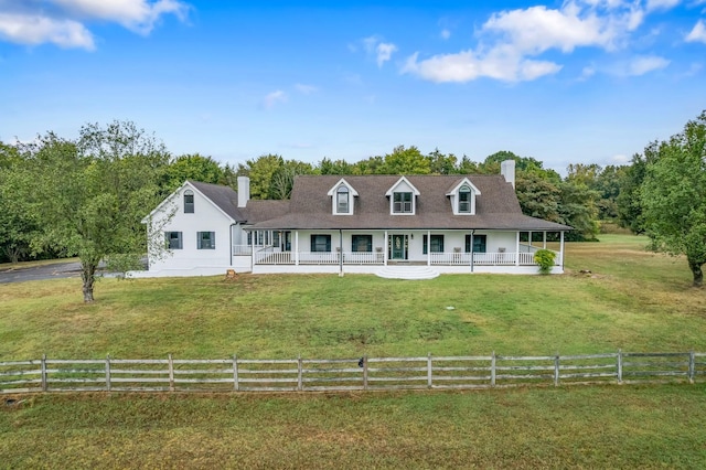 farmhouse-style home featuring a rural view, a front lawn, and covered porch