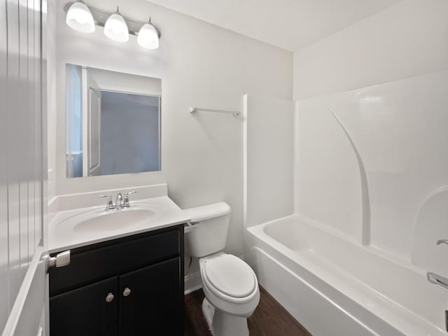 full bathroom featuring bathtub / shower combination, vanity, toilet, and hardwood / wood-style floors