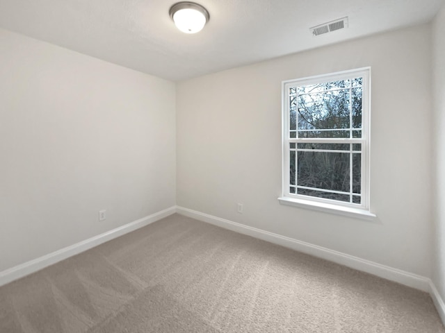 unfurnished room featuring carpet