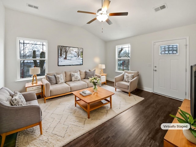 living room with lofted ceiling, hardwood / wood-style floors, and ceiling fan