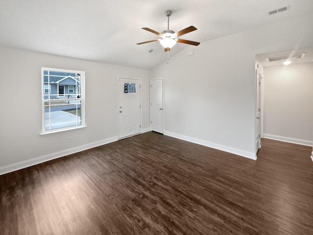 empty room featuring dark wood-type flooring, ceiling fan, and vaulted ceiling