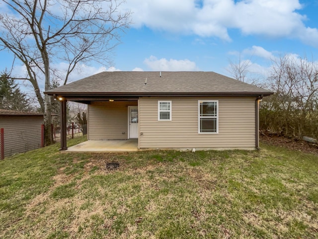 rear view of house featuring a lawn and a patio