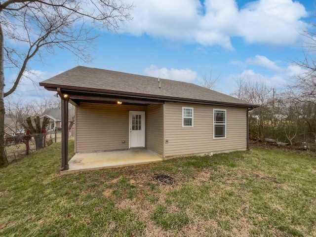 back of property featuring a lawn and a patio area