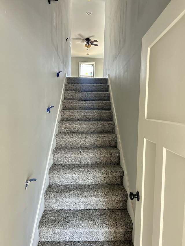 stairway featuring baseboards