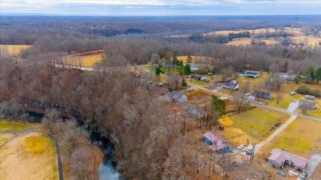 birds eye view of property featuring a forest view