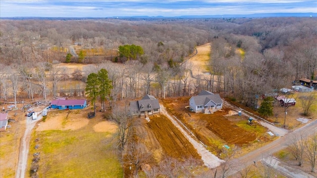 bird's eye view featuring a wooded view