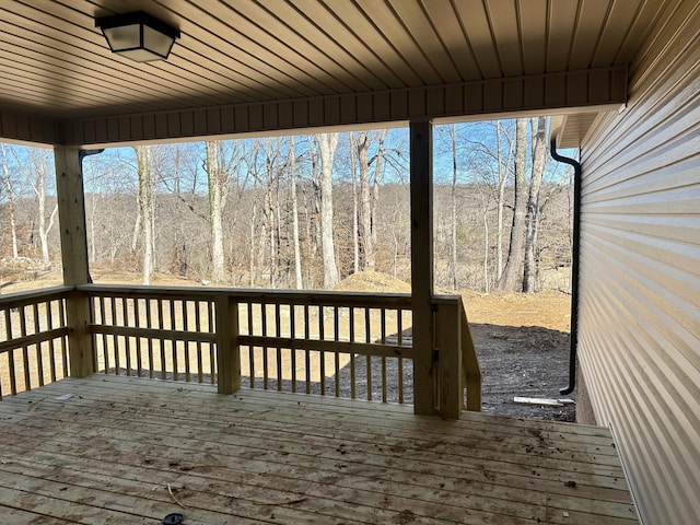 wooden terrace with a wooded view