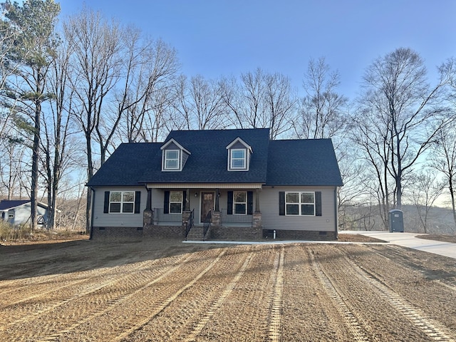 cape cod house featuring a shingled roof, dirt driveway, and crawl space