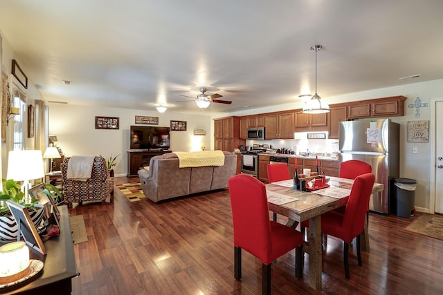 dining space with ceiling fan, dark hardwood / wood-style floors, and sink