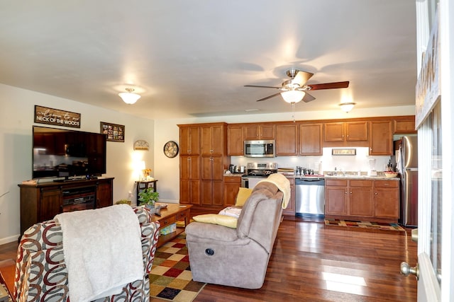 living room with dark wood-type flooring, sink, and ceiling fan