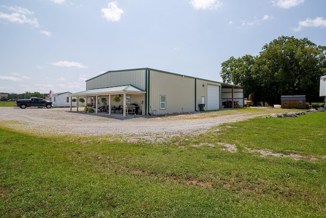 exterior space with an outbuilding, a garage, and a yard