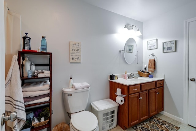 bathroom with vanity, tile patterned floors, and toilet