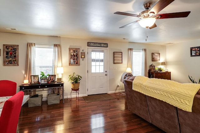 interior space featuring dark hardwood / wood-style flooring, multiple windows, and ceiling fan