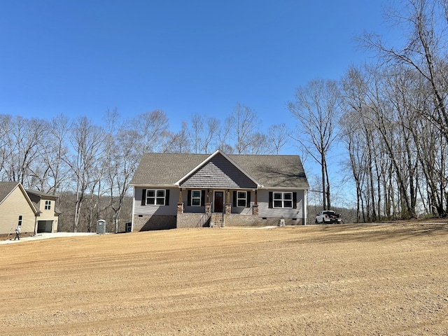 view of front facade with crawl space and roof with shingles