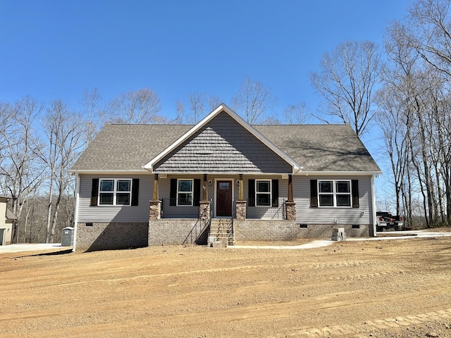 craftsman inspired home with crawl space, covered porch, and a shingled roof