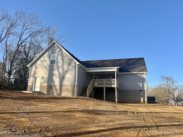 back of property featuring stairs