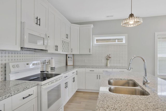 kitchen featuring white cabinetry, white appliances, sink, and hanging light fixtures