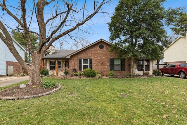 single story home with brick siding and a front lawn