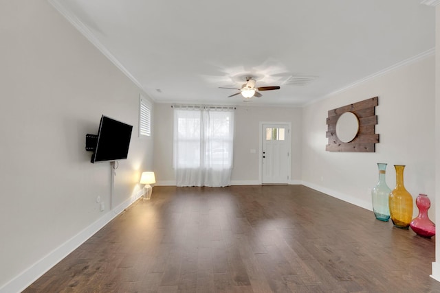 unfurnished living room featuring dark hardwood / wood-style flooring, ornamental molding, and ceiling fan