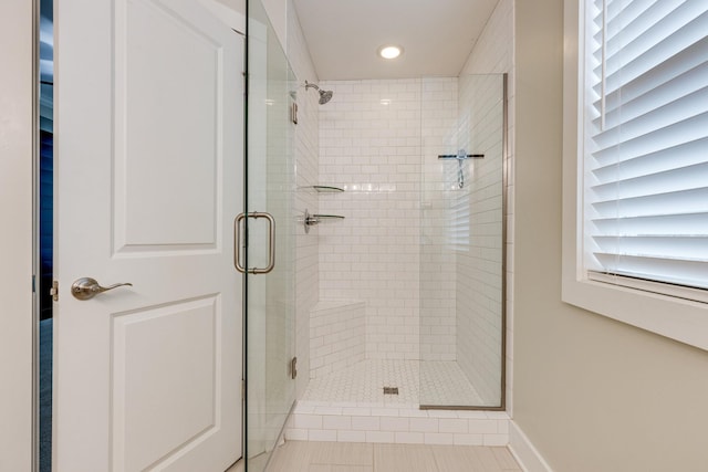 bathroom featuring a shower with shower door