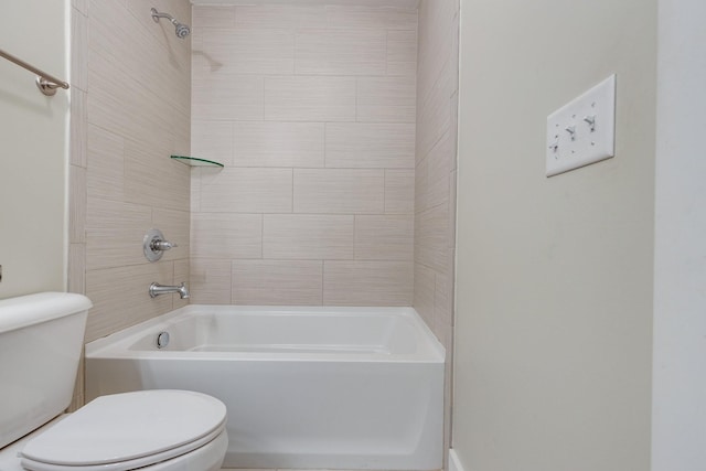 bathroom featuring tiled shower / bath and toilet