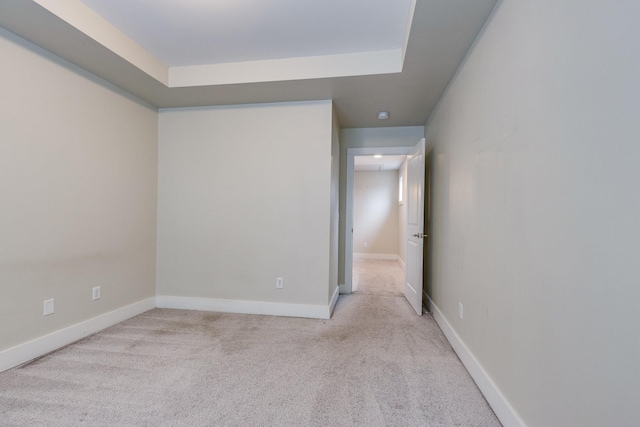 unfurnished room featuring light carpet