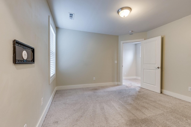 carpeted spare room featuring a healthy amount of sunlight