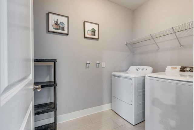 clothes washing area featuring washer and clothes dryer