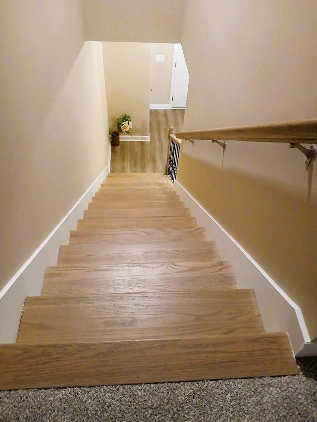 stairs featuring hardwood / wood-style flooring