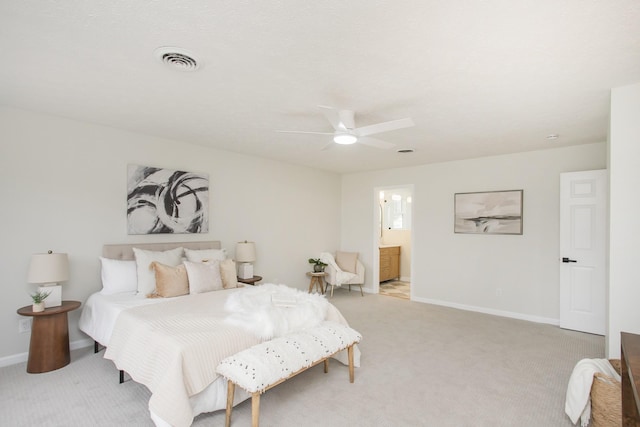 carpeted bedroom with connected bathroom and ceiling fan