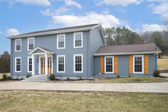 colonial-style house with a front yard