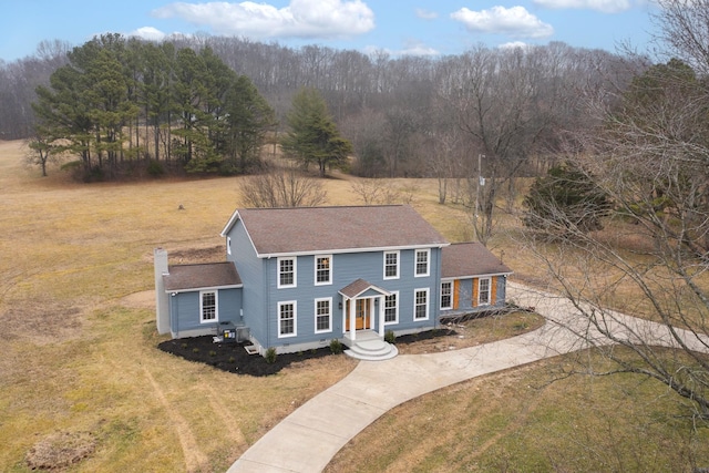 colonial home with a front lawn