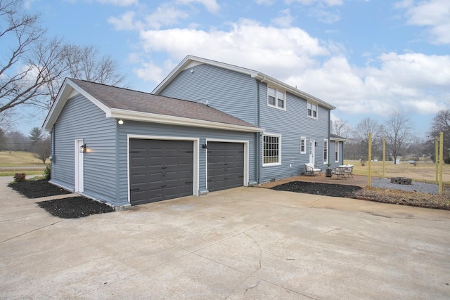 view of home's exterior with a garage and a patio