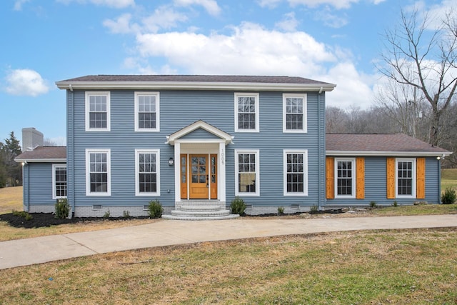 colonial house featuring a front yard