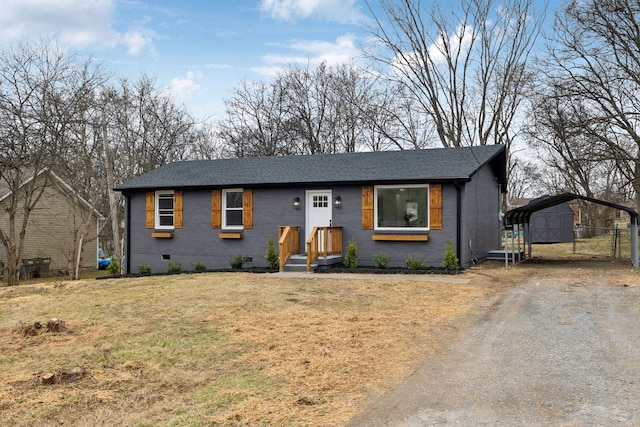 view of front of house with a front yard and a carport