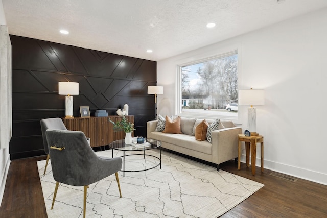 living room featuring hardwood / wood-style flooring and a textured ceiling