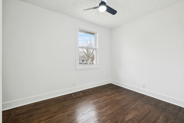 empty room with dark hardwood / wood-style flooring, ceiling fan, and a textured ceiling