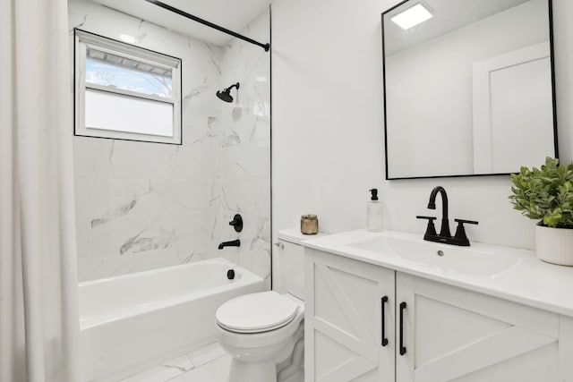 full bathroom featuring tiled shower / bath, vanity, and toilet