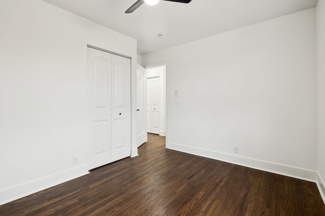 unfurnished bedroom featuring ceiling fan, dark hardwood / wood-style floors, and a closet