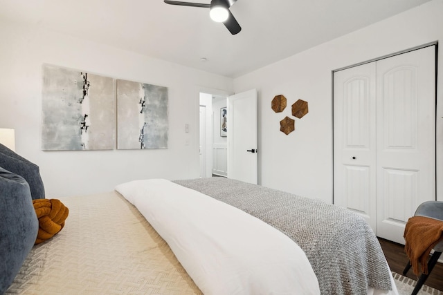 bedroom with hardwood / wood-style floors, a closet, and ceiling fan