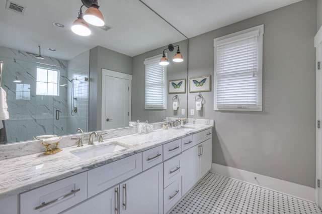 bathroom with walk in shower, tile patterned floors, and vanity