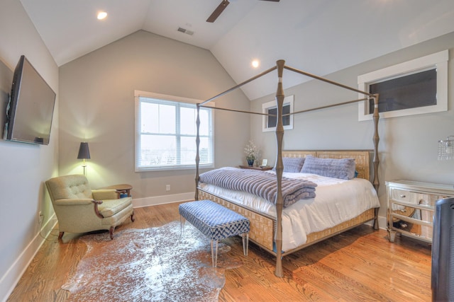 bedroom with hardwood / wood-style floors, vaulted ceiling, and ceiling fan